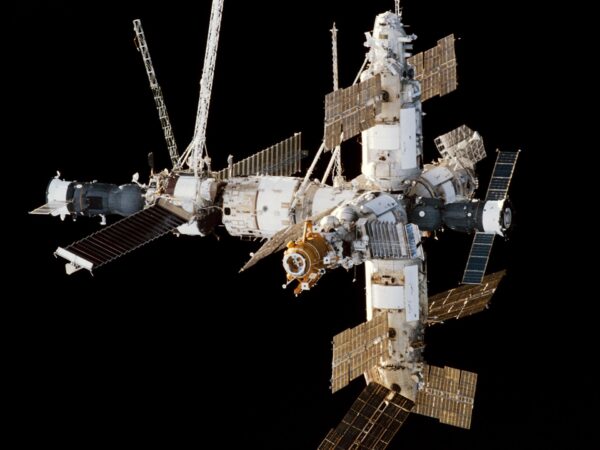 The Mir space station seen from the space shuttle Endeavour, with its solar panels and modules against the black of space