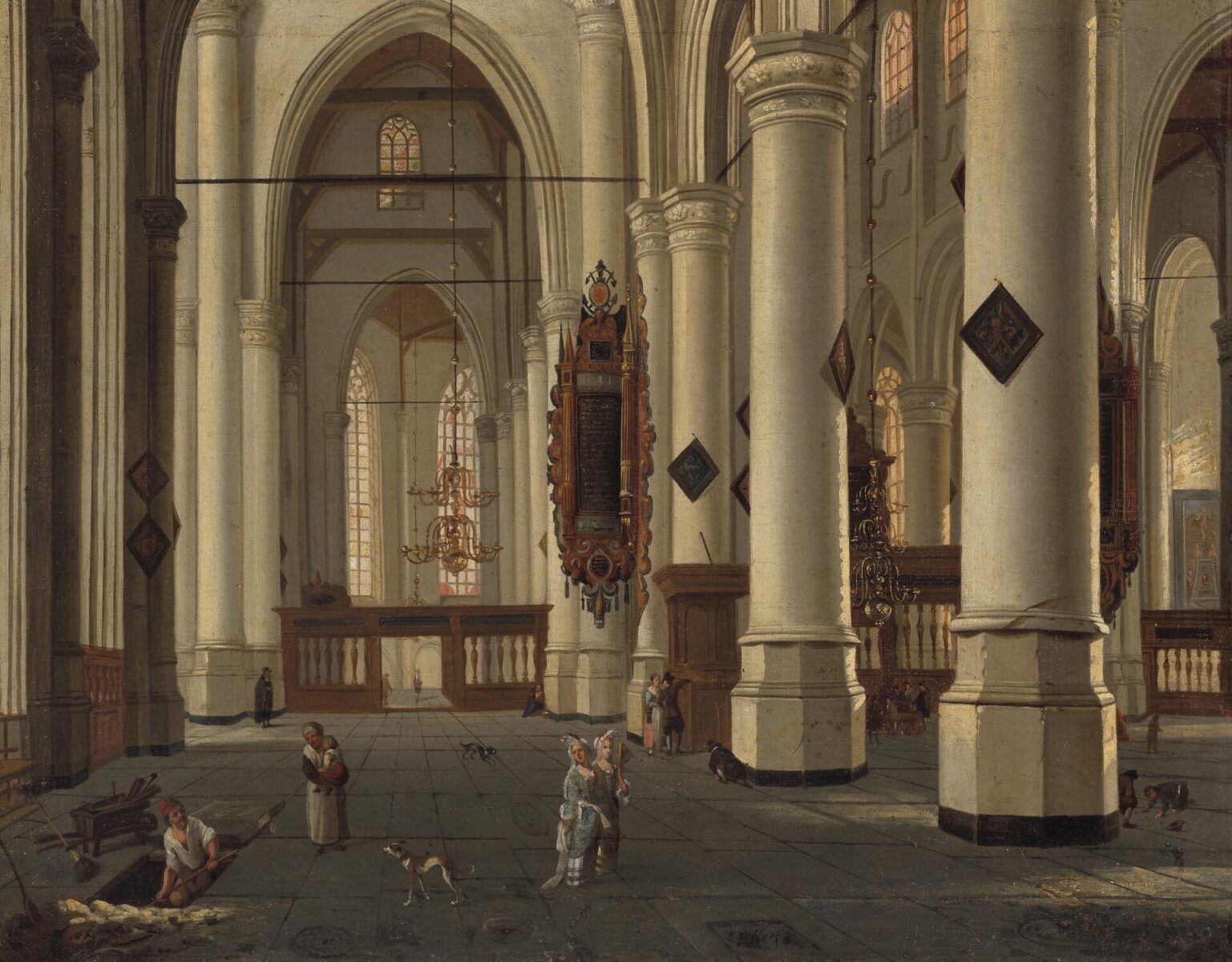 The light-filled interior of a whitewashed Gothic church, with tall columns and a few people walking across the floor.