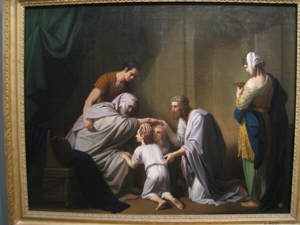 The aged Jacob, in bed near death, blesses his grandsons while Joseph and his family look on.