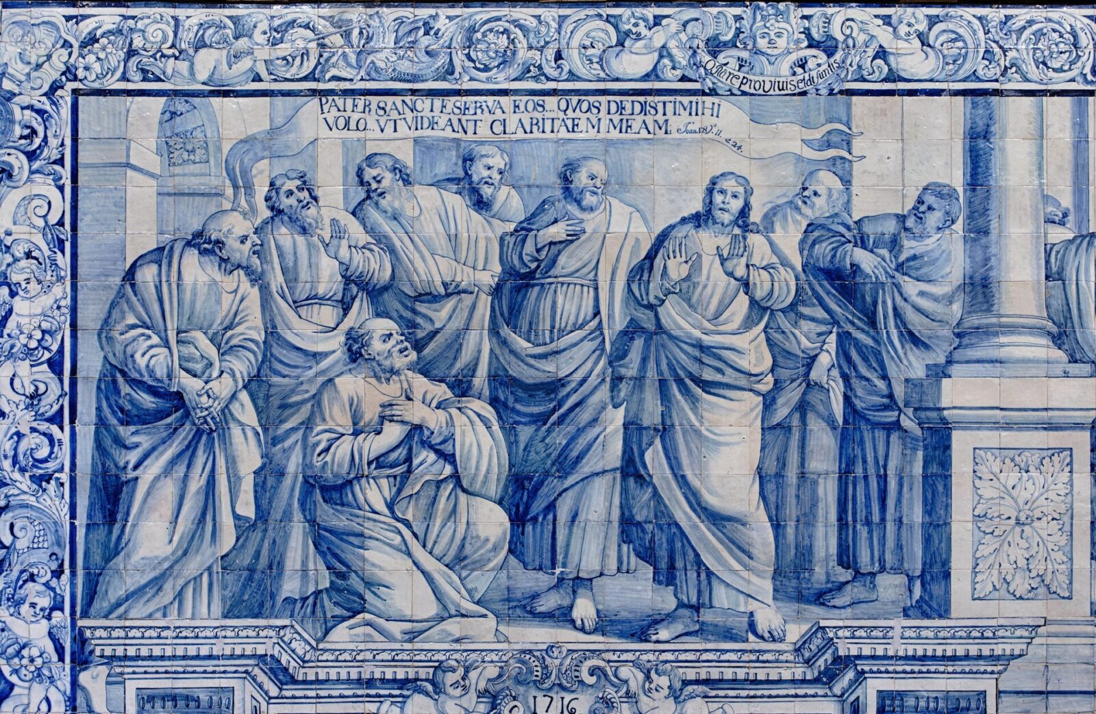 Blue and white tiles show Jesus praying to his Father with his disciples around him.