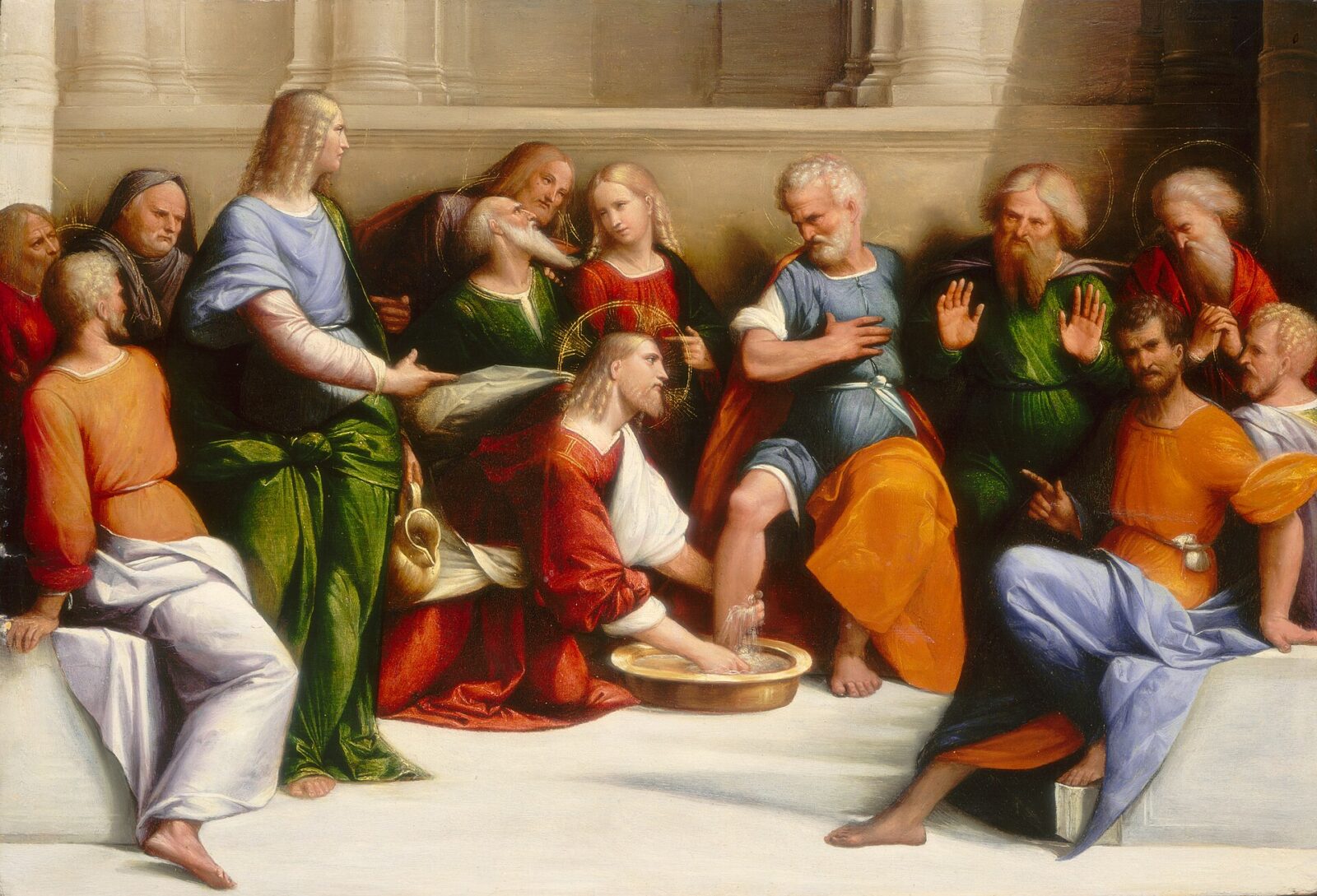 Christ kneels before Peter to wash his feet while the other disciples look on.