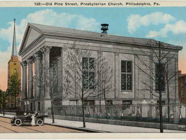 A brick church with a columned front and a tree-lined churchyard in Philadelphia.